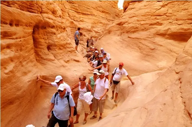Vibrant red and orange rock formations inside the Colored Canyon Dahab