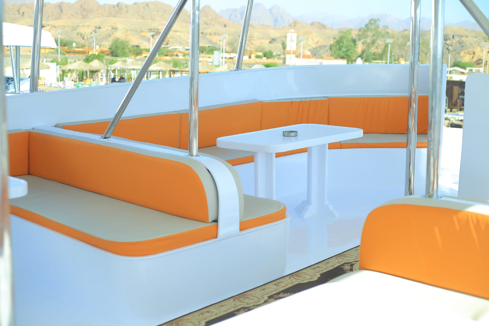 Comfortable boat interior with orange and white cushioned seating