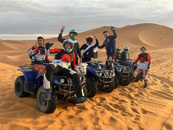 Group on quad bikes at sunset